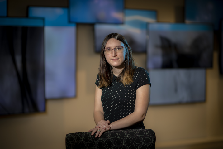 woman sitting in front of screens