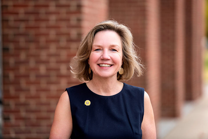 woman standing outside smiling at the camera