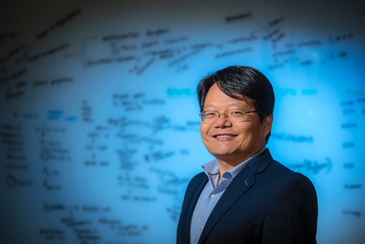 Man standing in front of whiteboard with notes