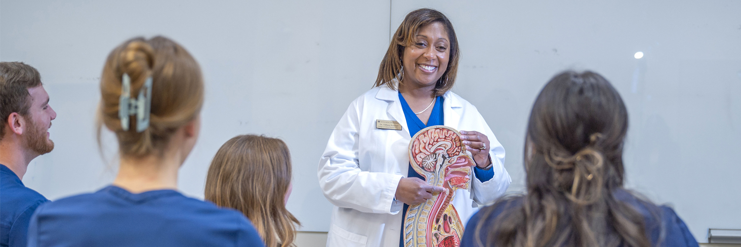Female instructor teaching a Speech Language Pathology class to a group of students