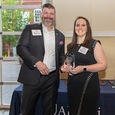 Summerville Alumni President Kyle Scott presents the Outstanding Young Alumni Award to Brooks Stagich