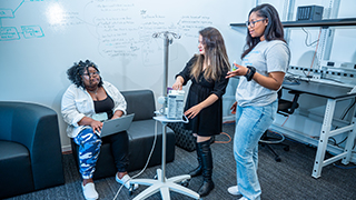 Students working at a computer in the lab