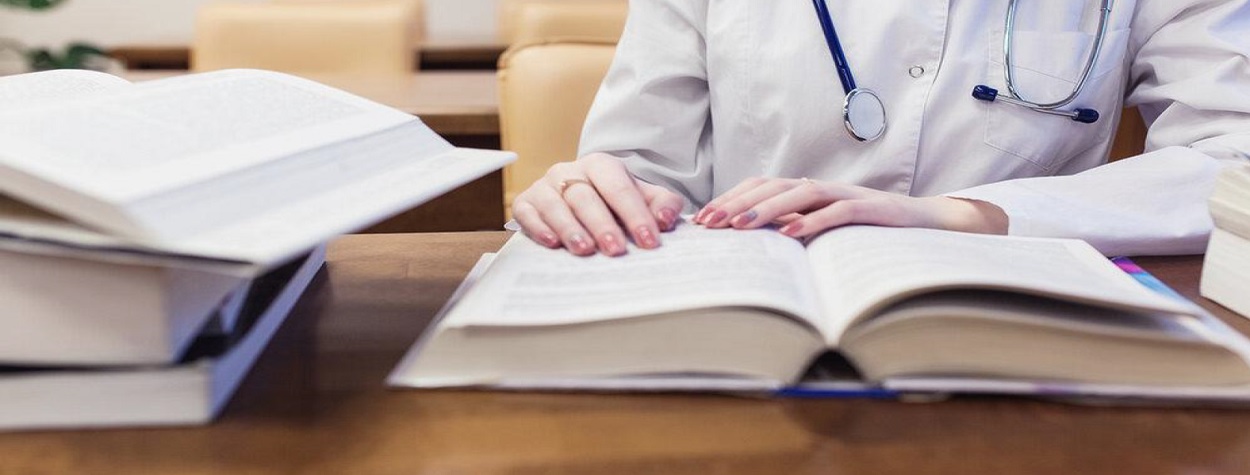 medical student studying a book