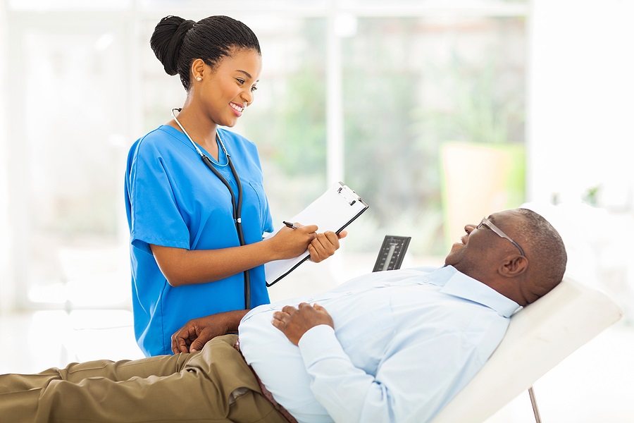 Doctor smiling talking to reclined patient