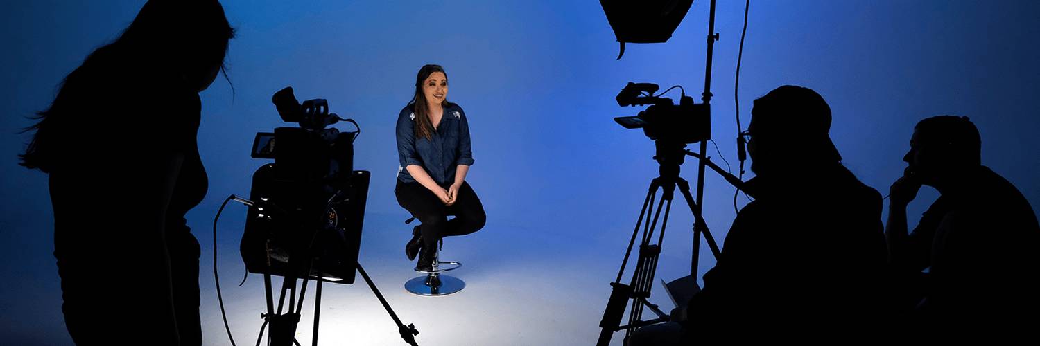 Communication students sitting in a video recording studio