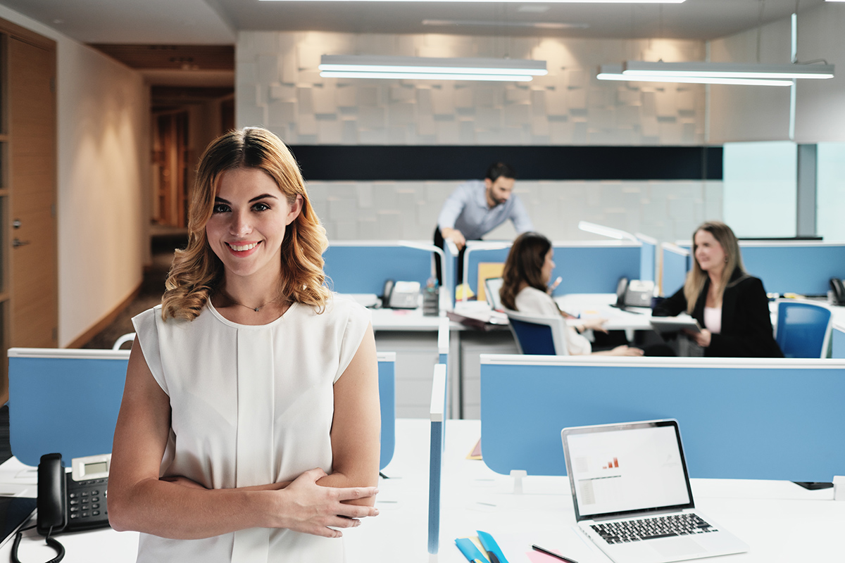 Human Resources - Professional woman standing in an office smiling