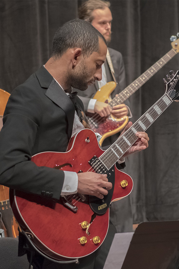 Students in the jazz ensemble play instruments on stage
