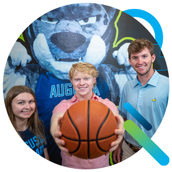 运动机能学 students hold a basketball at Christenberry fieldhouse