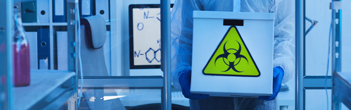 lab worker holding hazardous waste
