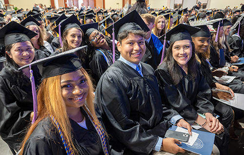 Graduates smiling at 毕业典礼