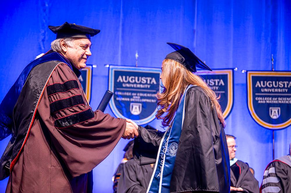 man shaking hands with student