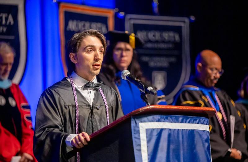 man speaking at podium