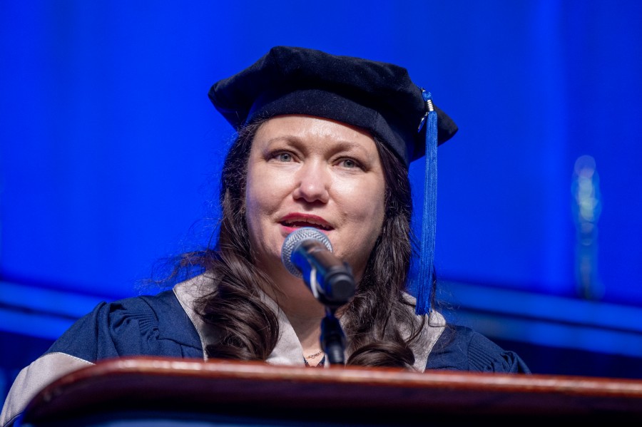 graduate speaking at podium