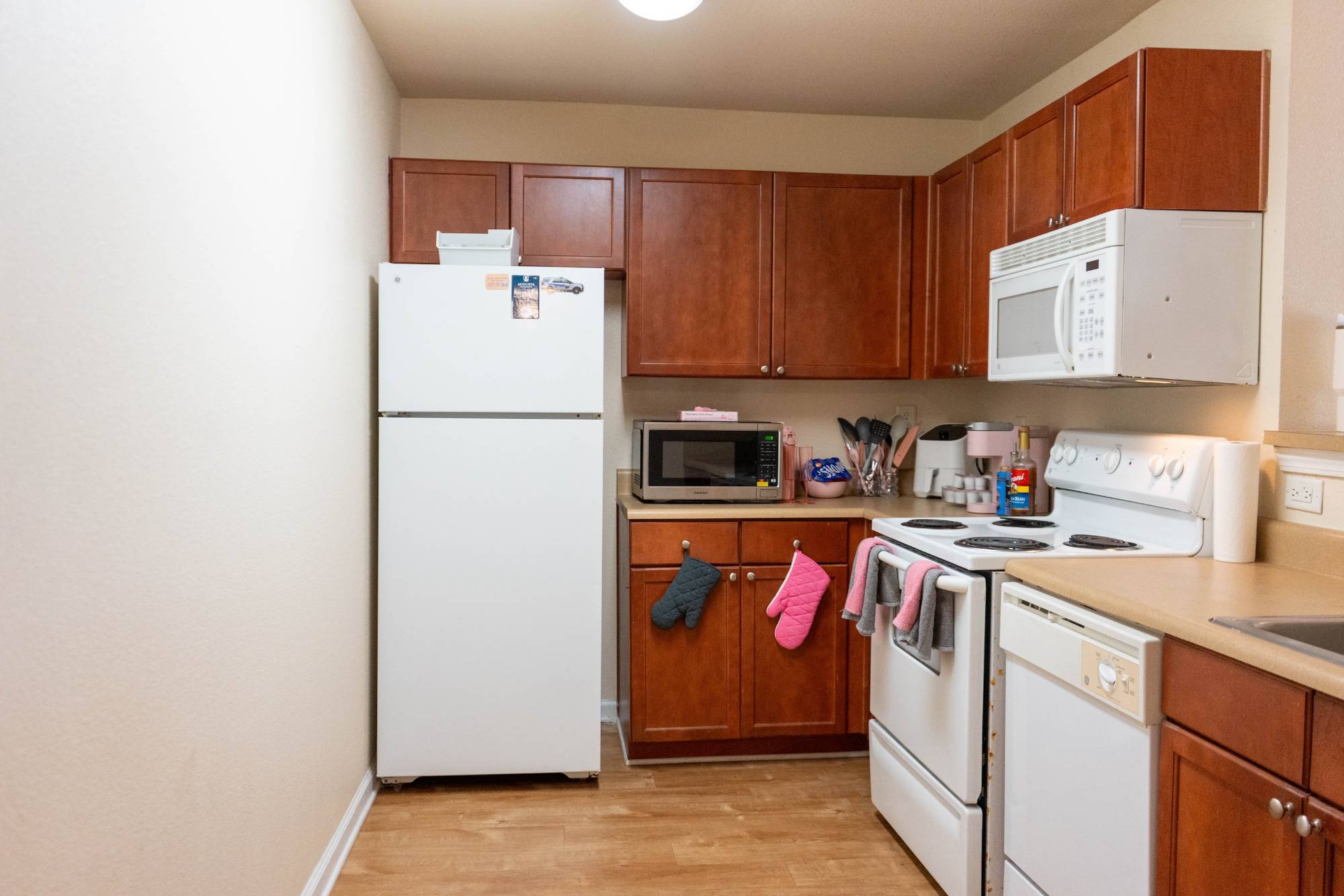 Kitchen includes, fridge, microwave, stove, oven, dishwasher, wood cabinets and sink
