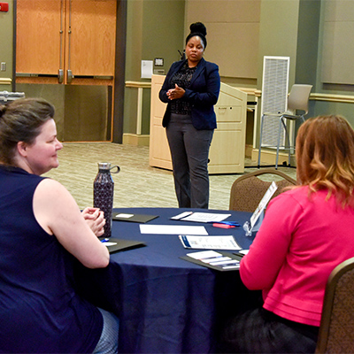 C.E.L. members at tables during the meeting