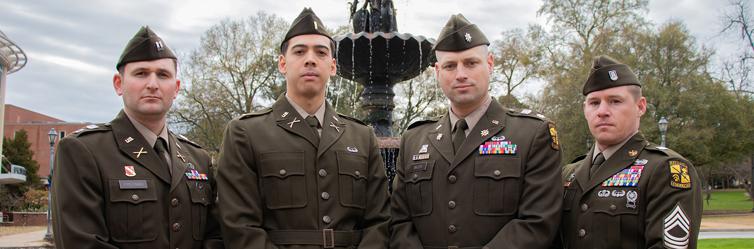 US Army Soldiers stand with arms crossed in front of AU Fountain