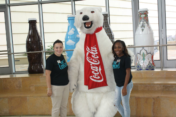 Crew students standing with a large Coca Cola polar bear