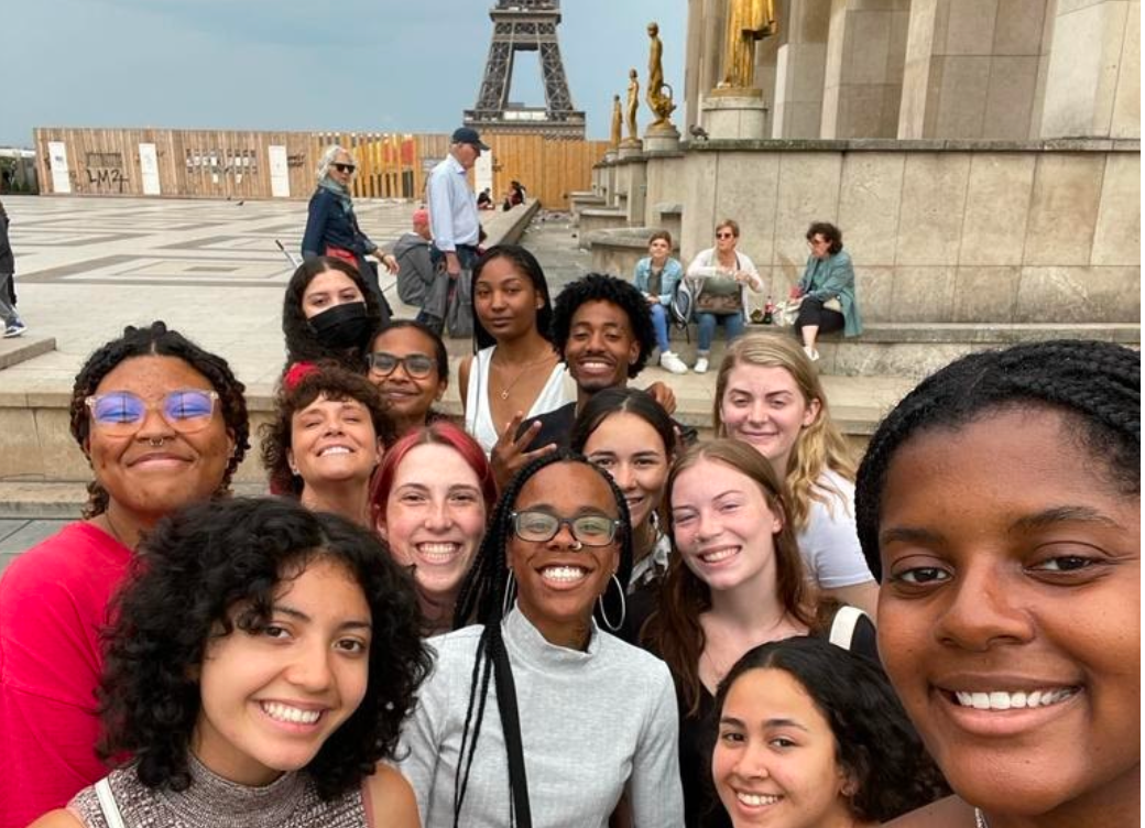 Student smiling in front of a group of students